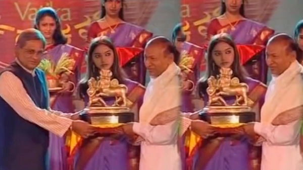 Who is the actress standing between SM Krishna and Dr Rajkumar in the photo