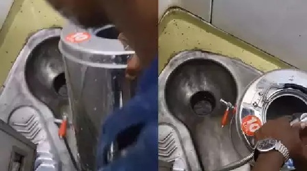 Man Washes Tea Container in Train Toilet