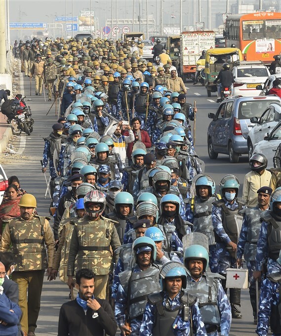 Security personnel conduct a flag march at Ghazipur border