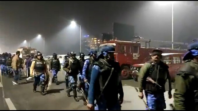 Security personnel conduct a flag march at Ghazipur border
