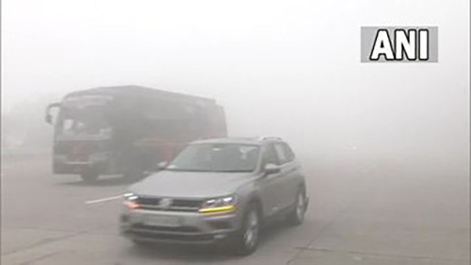 The thick layer of fog affects visibility at Yamuna Expressway