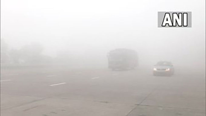 The thick layer of fog affects visibility at Yamuna Expressway