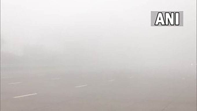 The thick layer of fog affects visibility at Yamuna Expressway