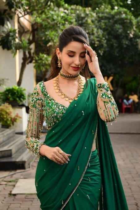 Bollywood Actress Nora Fatehi Looks Stunning In Green Saree