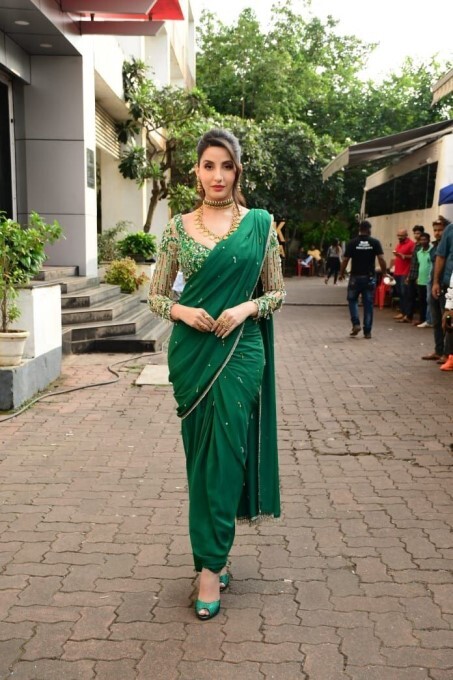 Bollywood Actress Nora Fatehi Looks Stunning In Green Saree