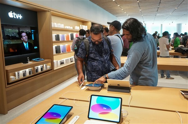 People visit India's first Apple retail store after its opening, at BKC in Mumbai