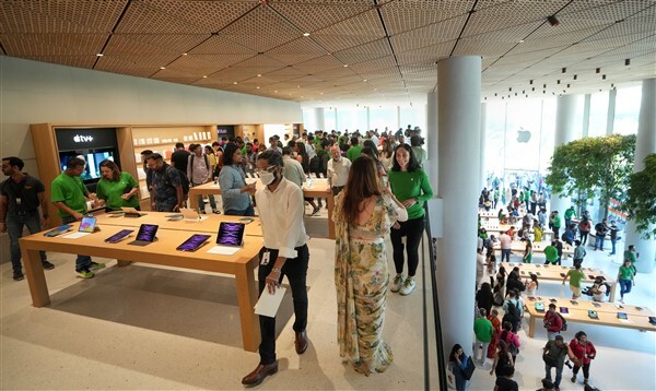 People visit India's first Apple retail store after its opening, at BKC in Mumbai
