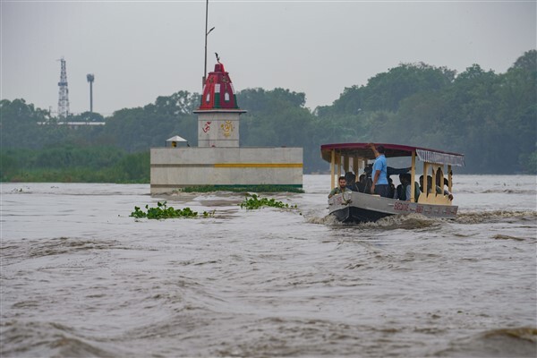 People from low-lying areas around the Yamuna river relocating to a safer place