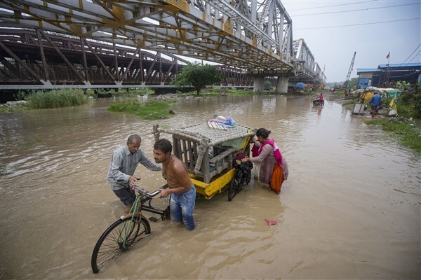 People from low-lying areas around the Yamuna river relocating to a safer place