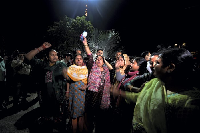 Women shout slogans in support of Delhi Chief Minister Arvind Kejriwal outside his residence
