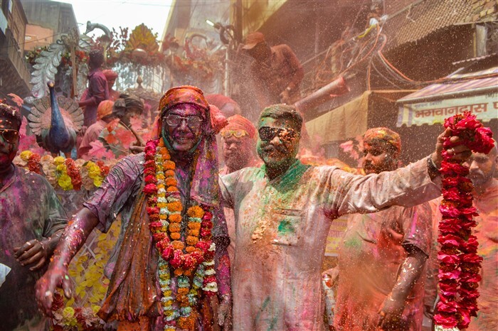 People play with colours ahead of the festival of Holi