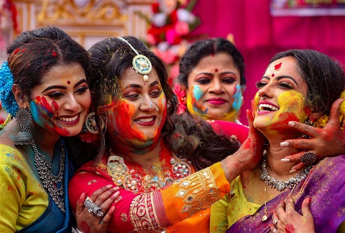 Women play Holi at Balurghat