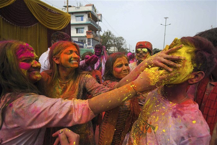 People play with colours during Holi celebrations