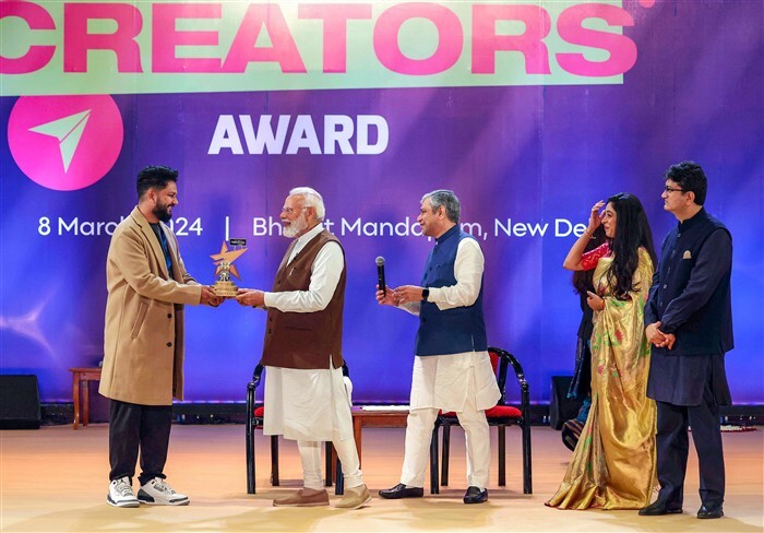 Prime Minister Narendra Modi presents the Best Creator in Education Category award to Naman Deshmukh
