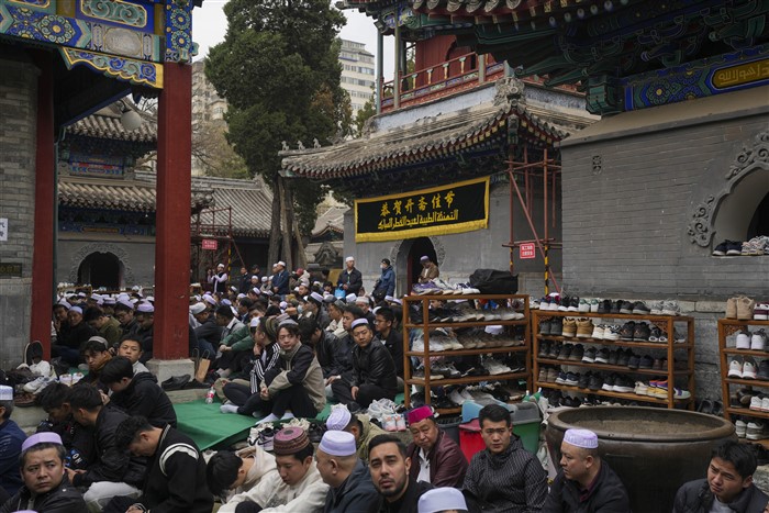 Muslim men attend the Eid al-Fitr prayers to mark the end of the holy fasting month of Ramadan at the Niujie Mosque in Beijing, China.