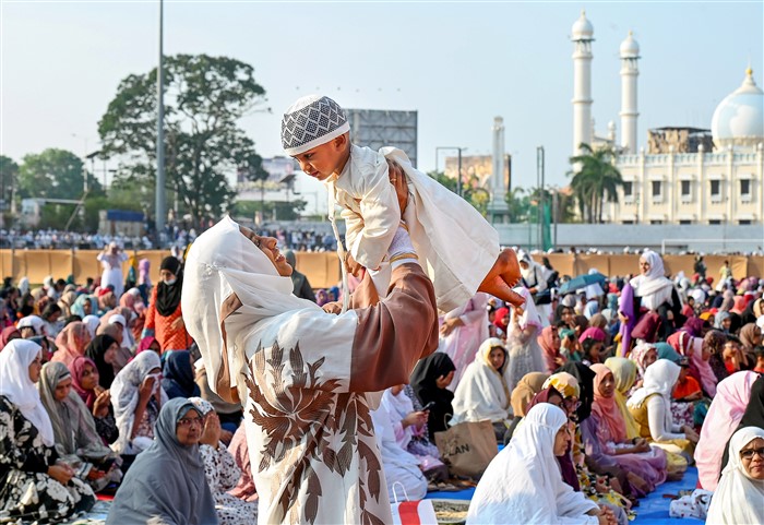 A Muslim devotee with her child during Eid al-Fitr, marking the end of the holy month of Ramzan, in Thiruvananthapuram
