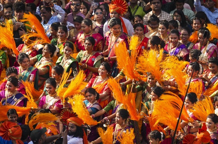 People dressed in traditional attire participate in a rally