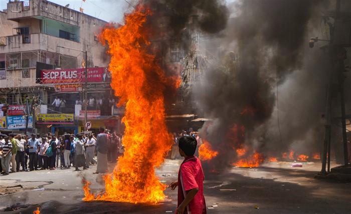 Devotees burn camphor blocks as part of a ritual during the celebration of 'Karaga' festival, at Dharamraya Swamy temple in Bengaluru