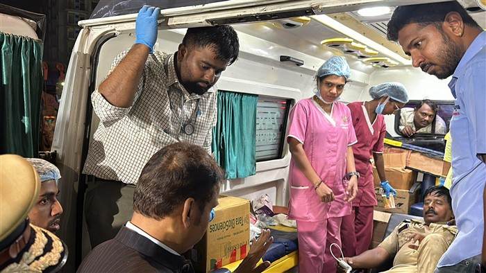 Maharashtra Dy CM Devendra Fadnavis interacts with an injured as he visits the hoarding collapse site at Ghatkopar.