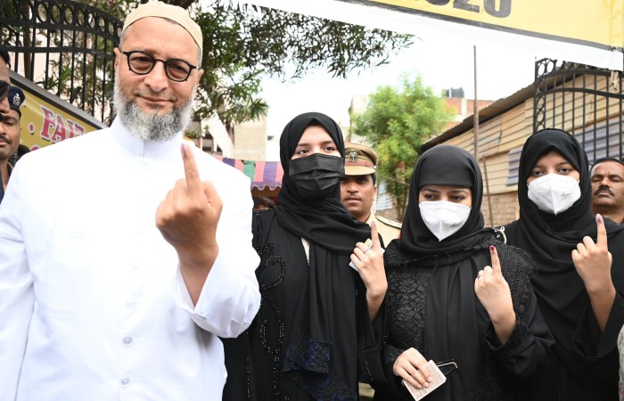 Hyderabad: AIMIM's Asaduddin Owaisi shows his inked finger along with his family members after casting his vote