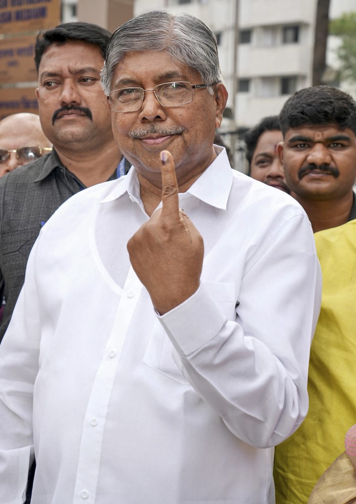 Pune: BJP leader Chandrakant Patil shows his finger marked with indelible ink after casting his vote