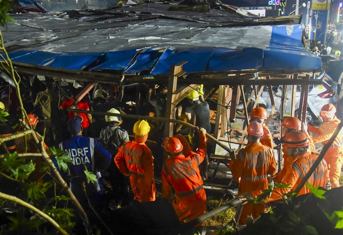 Rescue work underway after a huge billboard collapsed on a petrol pump