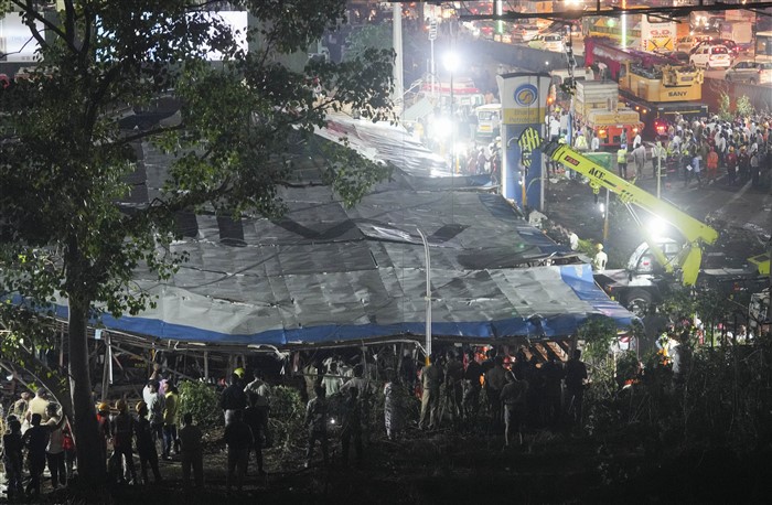 Rescue work underway after a huge billboard collapsed on a petrol pump due to strong winds and rain, at Ghatkopar in Mumbai