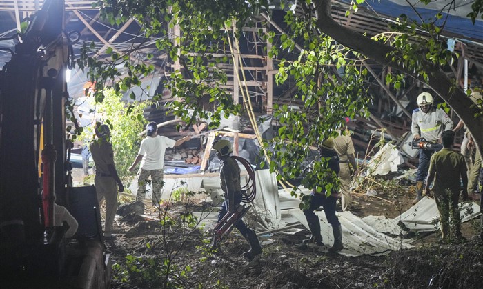 Rescue work underway after a huge billboard collapsed on a petrol pump