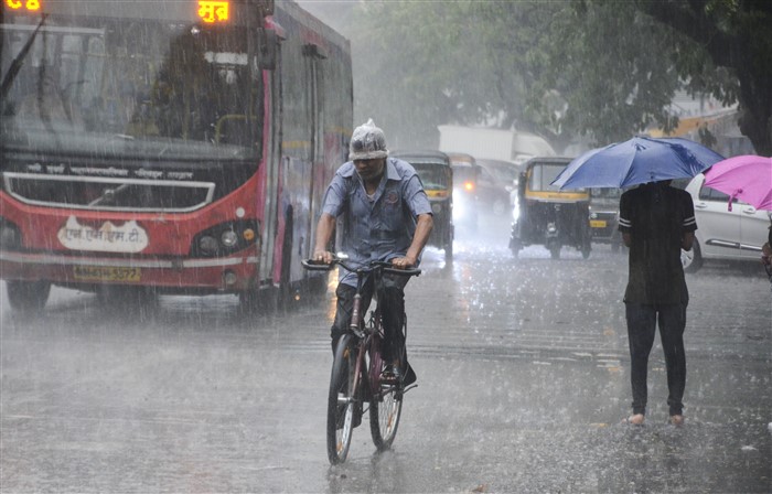 Vehicles move on a road amid rain, at Vashi, in Navi Mumbai.