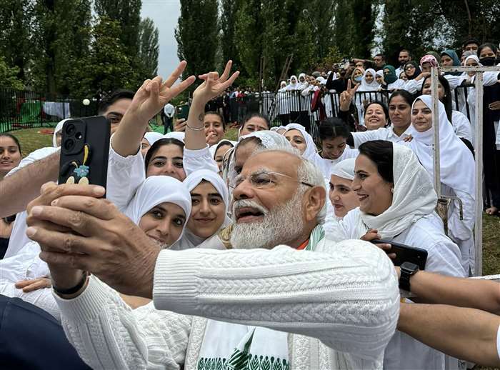Prime Minister Narendra Modi takes a selfie with people