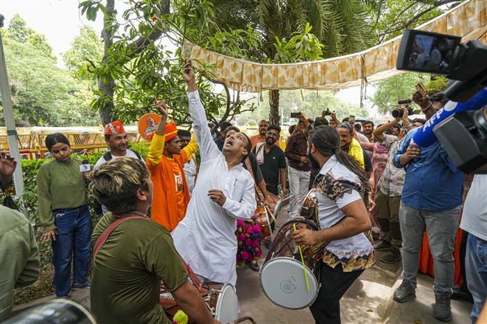 BJP supporters celebrate the party's lead during counting of votes for Lok Sabha elections, at BJP headquarters in New Delhi.