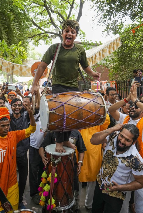 BJP supporters celebrate the party's lead in the Lok Sabha elections at party headquarters as counting of votes underway, in New Delhi.