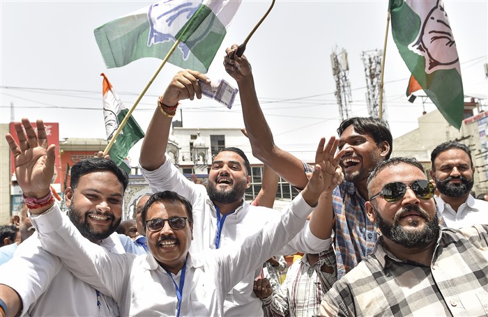 Congress supporters celebrate the party's lead during counting of votes for Lok Sabha elections, in Jalandhar.
