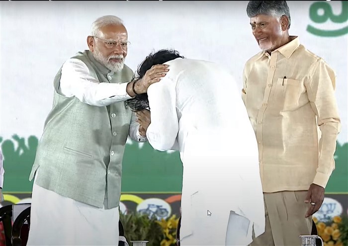 PM Narendra Modi greets Janasena chief Pawan Kalyan as Andhra Pradesh CM Nara Chandrababu Naidu looks on during the swearing-in ceremony, in Vijayawada