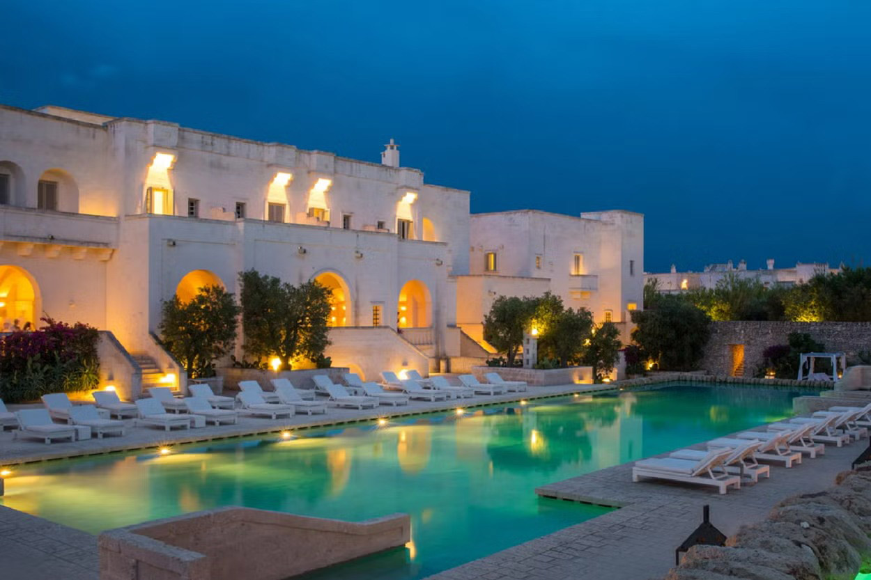 Borgo Egnazia, nestled in Puglia's olive groves and rolling countryside, features 192 rooms, passageways, and arches leading to a village square.