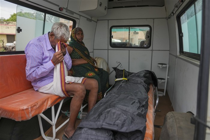 Family members mourn after receiving the body of a victim of the Hathras stampede that occured during a religious gathering, outside a hospital in Hathras district.
