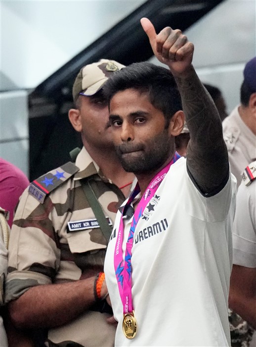 Indian cricketer Surya Kumar Yadav waves upon his arrival at New Delhi airport