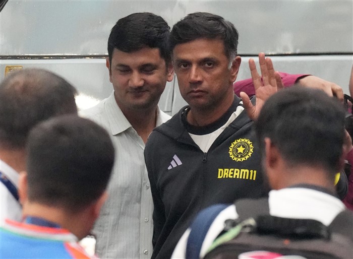Indian men's cricket team outgoing head coach Rahul Dravid waves at fans upon his arrival at New Delhi airport