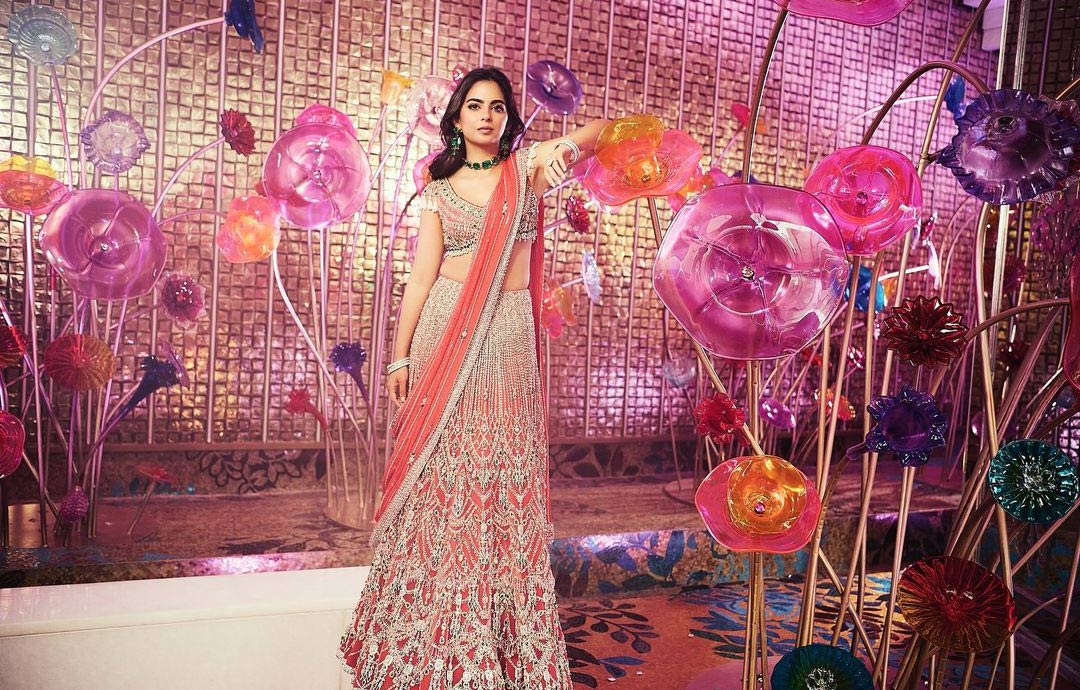 Isha chose a pink Falguni Shane Peacock lehenga set featuring a bralette, an A-line lehenga skirt and matching dupatta.