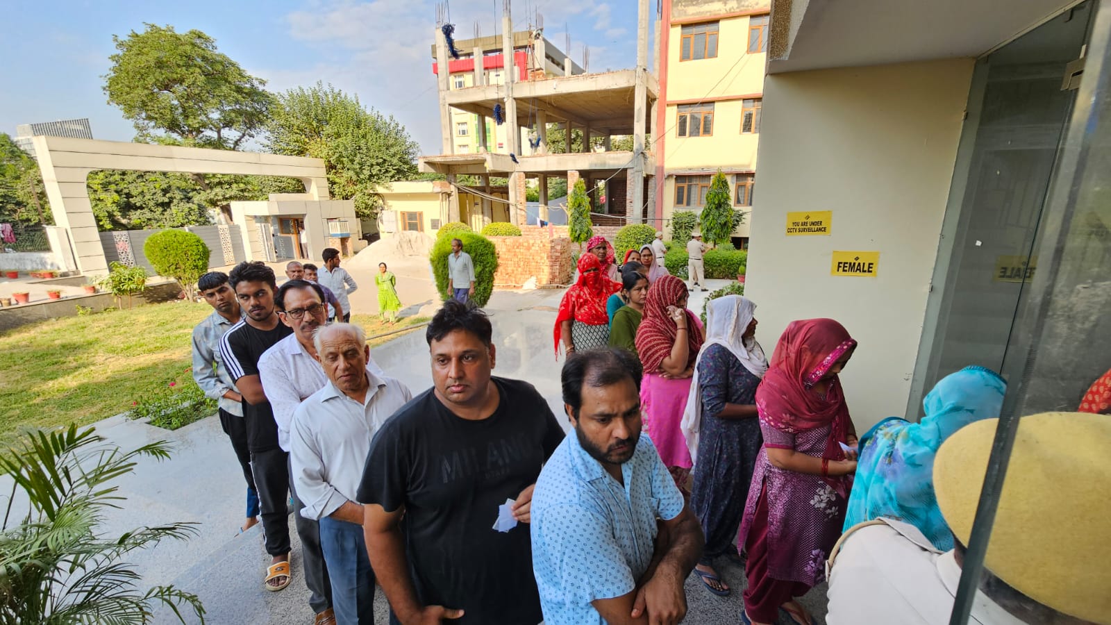 Citizens are actively participating, forming long lines outside polling stations.