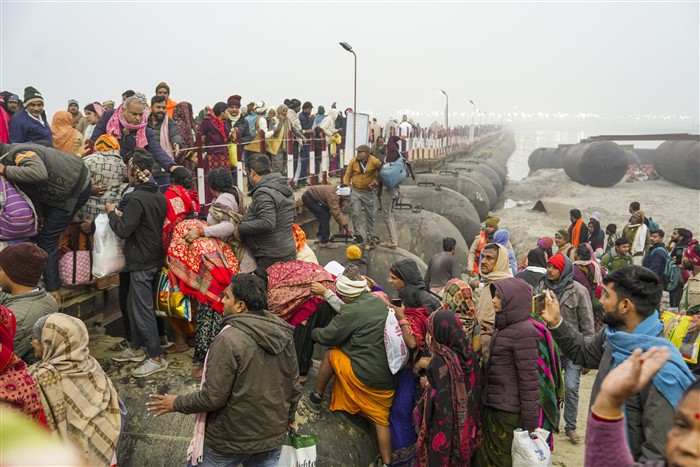 Devotees gathered to take a holy dip try to take an alternative route, on the first day of Maha Kumbh Mela 2025, at the Sangam in Prayagraj, Uttar Pradesh, Monday, Jan. 13, 2025.