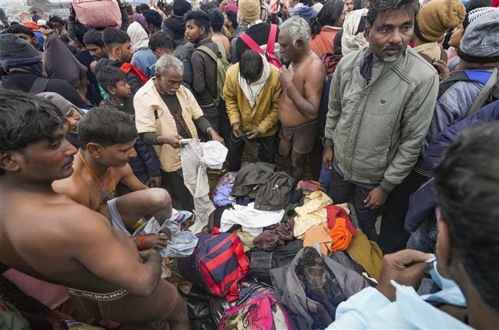 Devotees gather to take a holy dip at the Sangam on the first day of Maha Kumbh Mela 2025, in Prayagraj, Uttar Pradesh, Monday, Jan. 13, 2025.