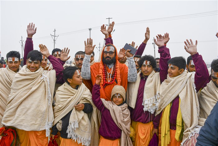 Devotees gather to take a holy dip at Sangam on the first day of Maha Kumbh Mela 2025, in Prayagraj, Uttar Pradesh, Monday, Jan. 13, 2025.