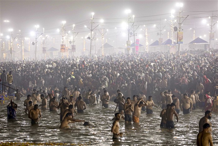 Devotees take a holy dip at Sangam on the first day of Maha Kumbh Mela 2025, in Prayagraj, Uttar Pradesh, Monday, Jan. 13, 2025.