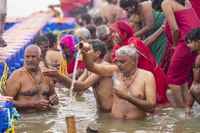 Devotees take a holy dip at Sangam on the first day of Maha Kumbh Mela 2025, in Prayagraj, Uttar Pradesh, Monday, Jan. 13, 2025.