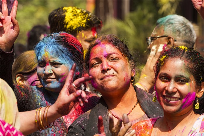 Women pose for pictures while celebrating Holi, in Ghaziabad, Friday, March 14, 2025.