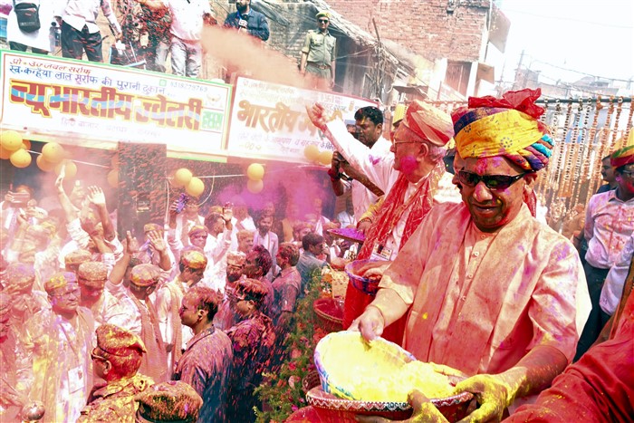 In this image released by @myogioffice, Friday, March 14, 2025, Uttar Pradesh Chief Minister Yogi Adityanath hurls coloured powder on people during a procession on the occasion of Holi, in Gorakhpur.
