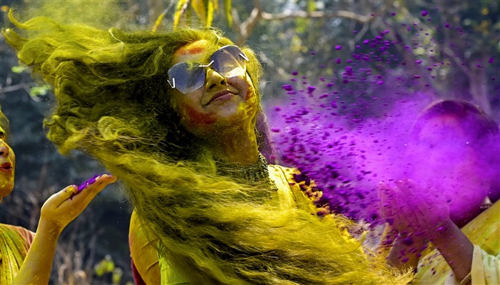 A woman smeared in coloured powder during Holi celebrations, in Nadia on Friday, March 14, 2025.