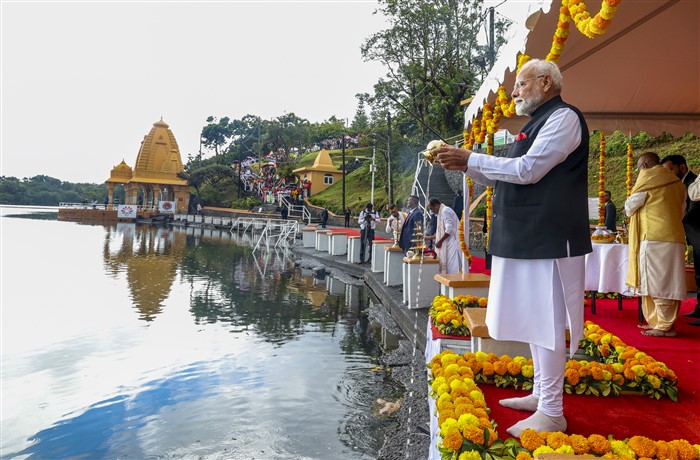 PMO on March 12, 2025, Prime Minister Narendra Modi offers 'Ganga Jal' into Ganga Talao, at the Ganga Talao in Mauritius.