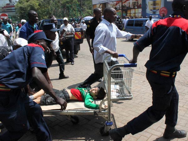 A injured child is wheeled away on a shopping trolley outside the Westgate Mall in Nairobi, Kenya